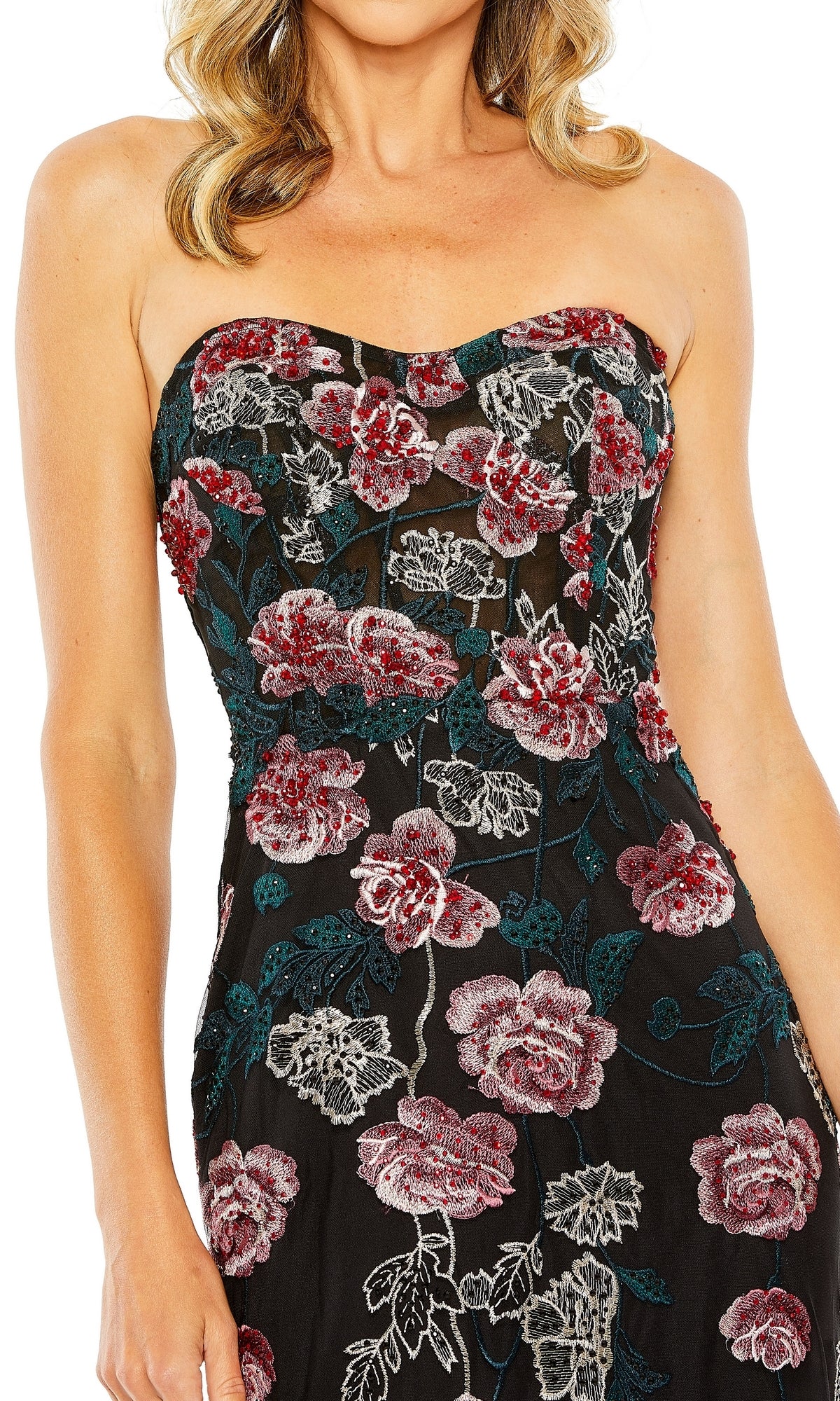 A woman wears the Long Formal Dress 20581 by Mac Duggal, a strapless fitted gown with red, pink, and green floral embroidery. The sweetheart neckline flatters her upper body; her face is partially out of frame.